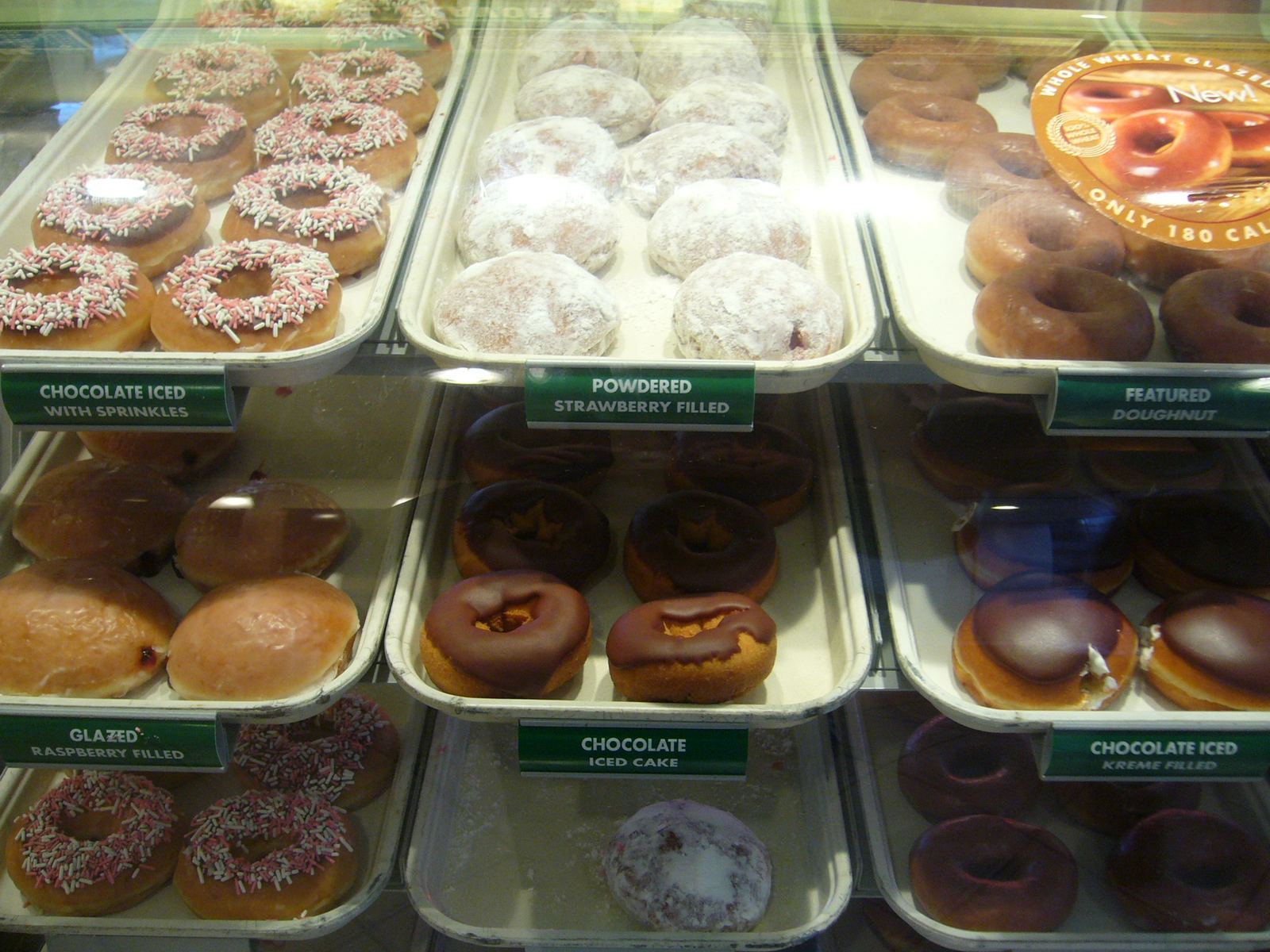 An assortment of glazed and frosted doughnuts