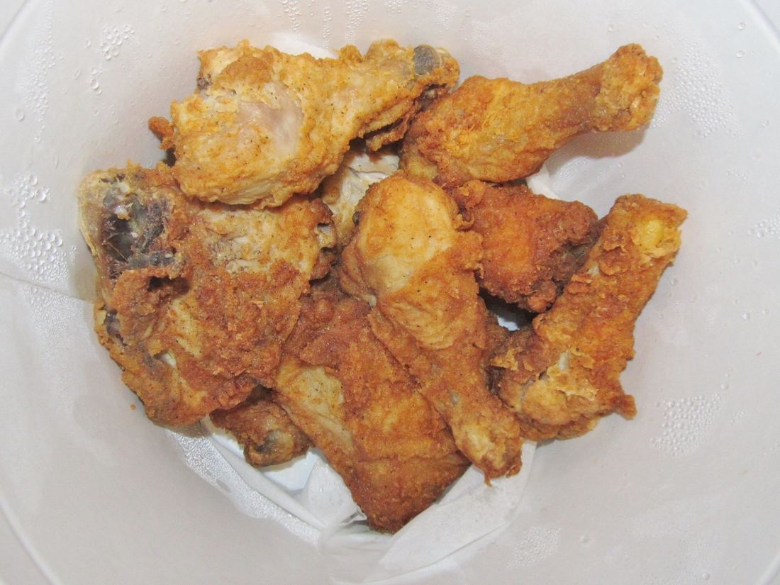 Looking down into a bucket of fried chicken